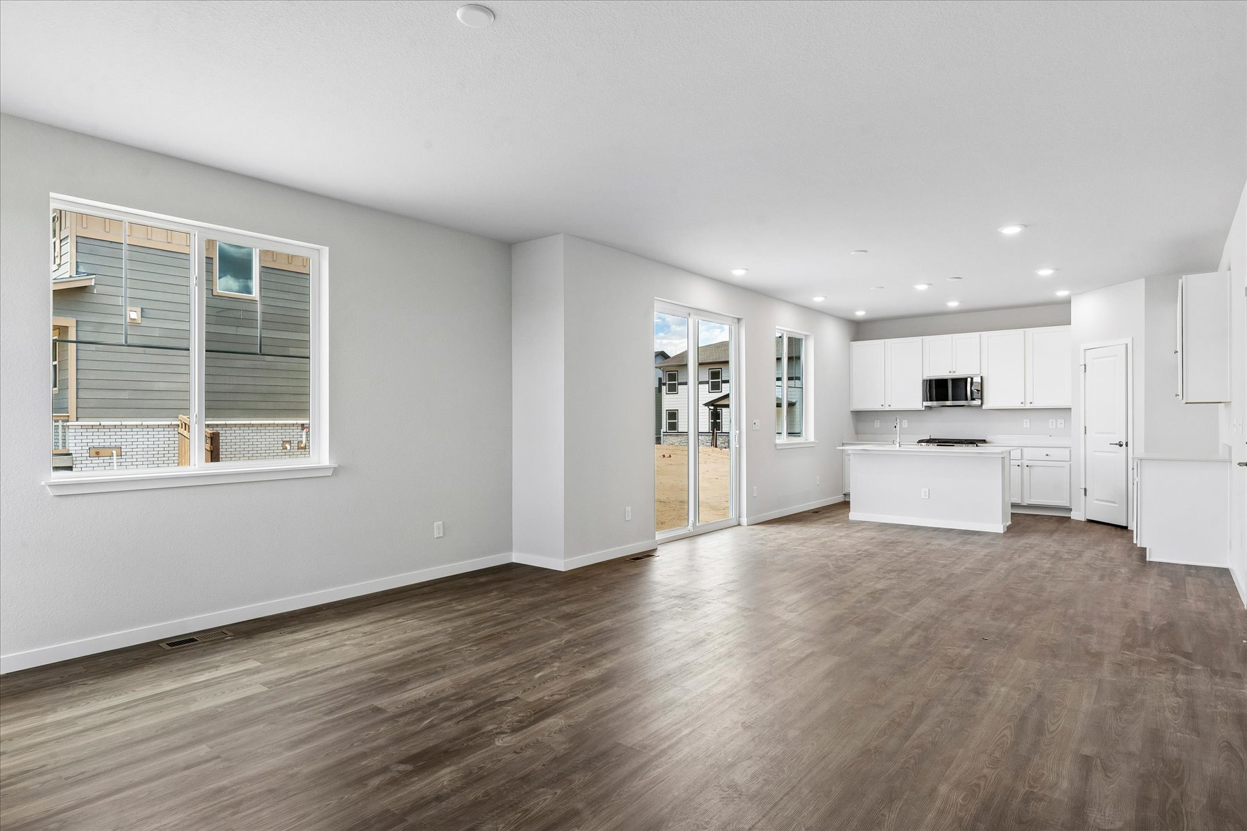 A large empty room with white cabinets.