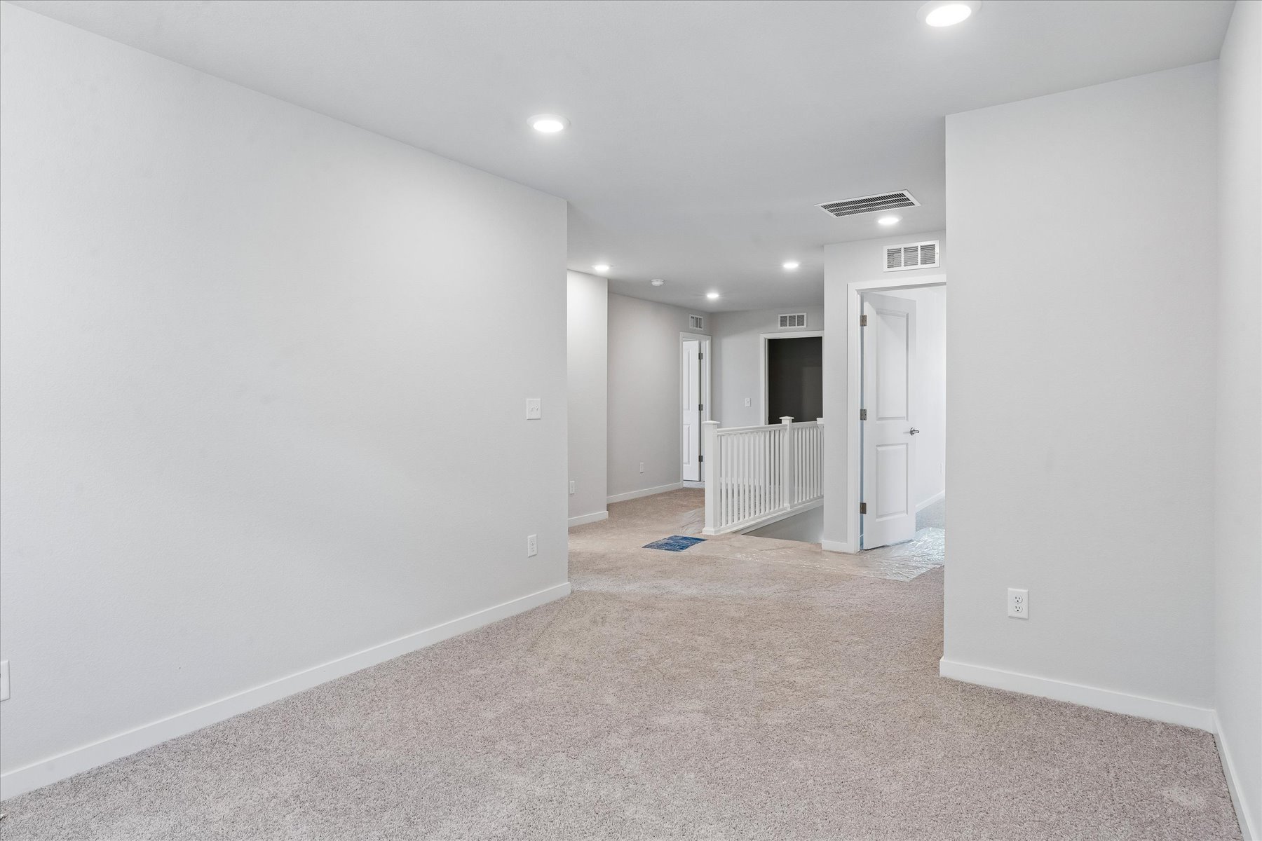 A hallway with white walls.