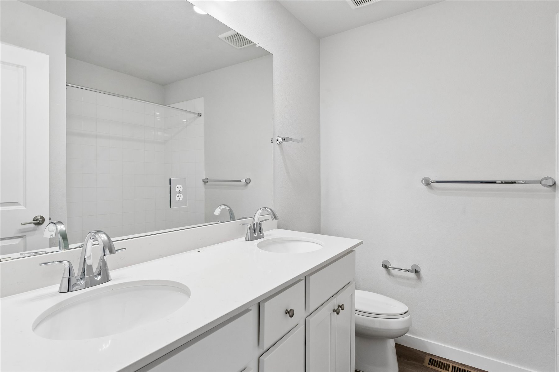 A bathroom with a large mirror.