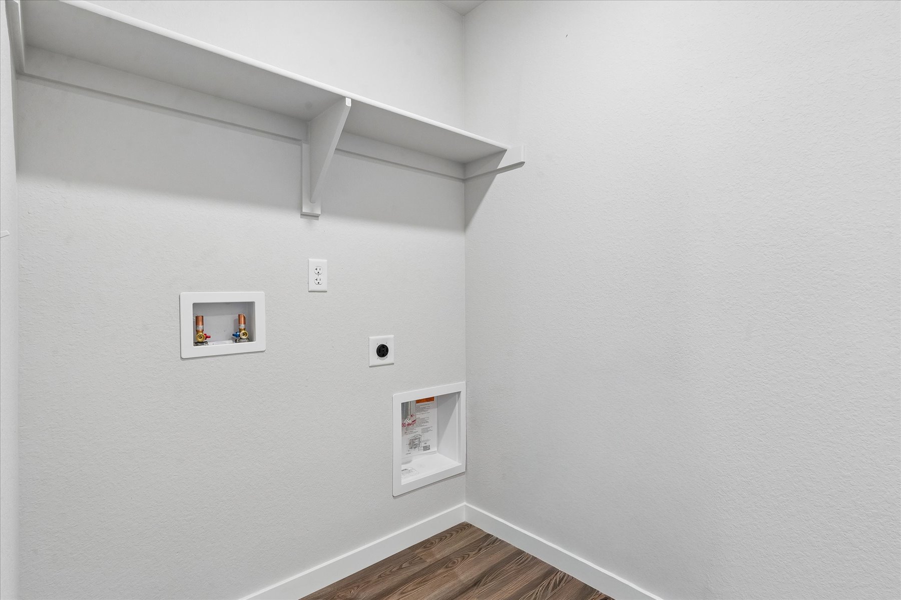 A white wall with pictures on it.