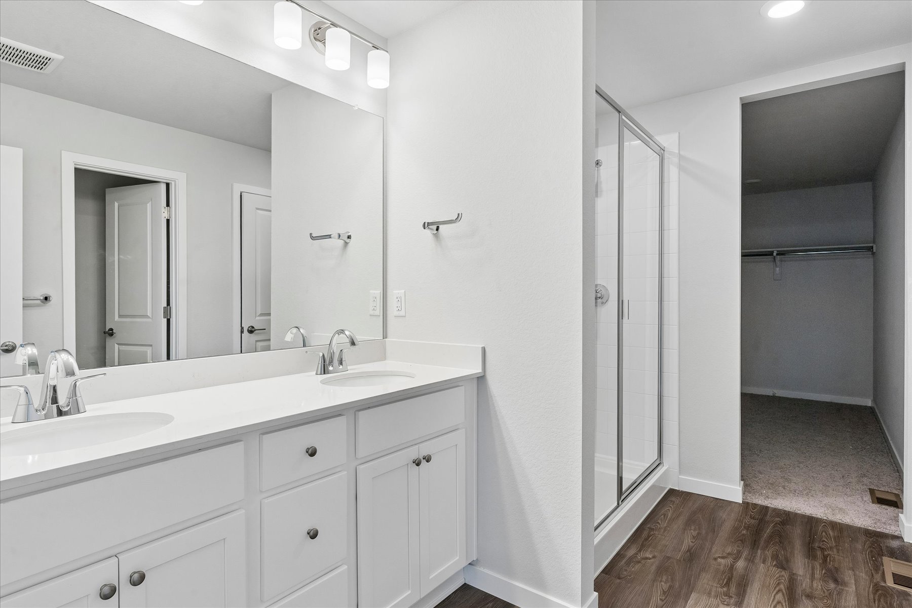 A bathroom with a shower and sink.