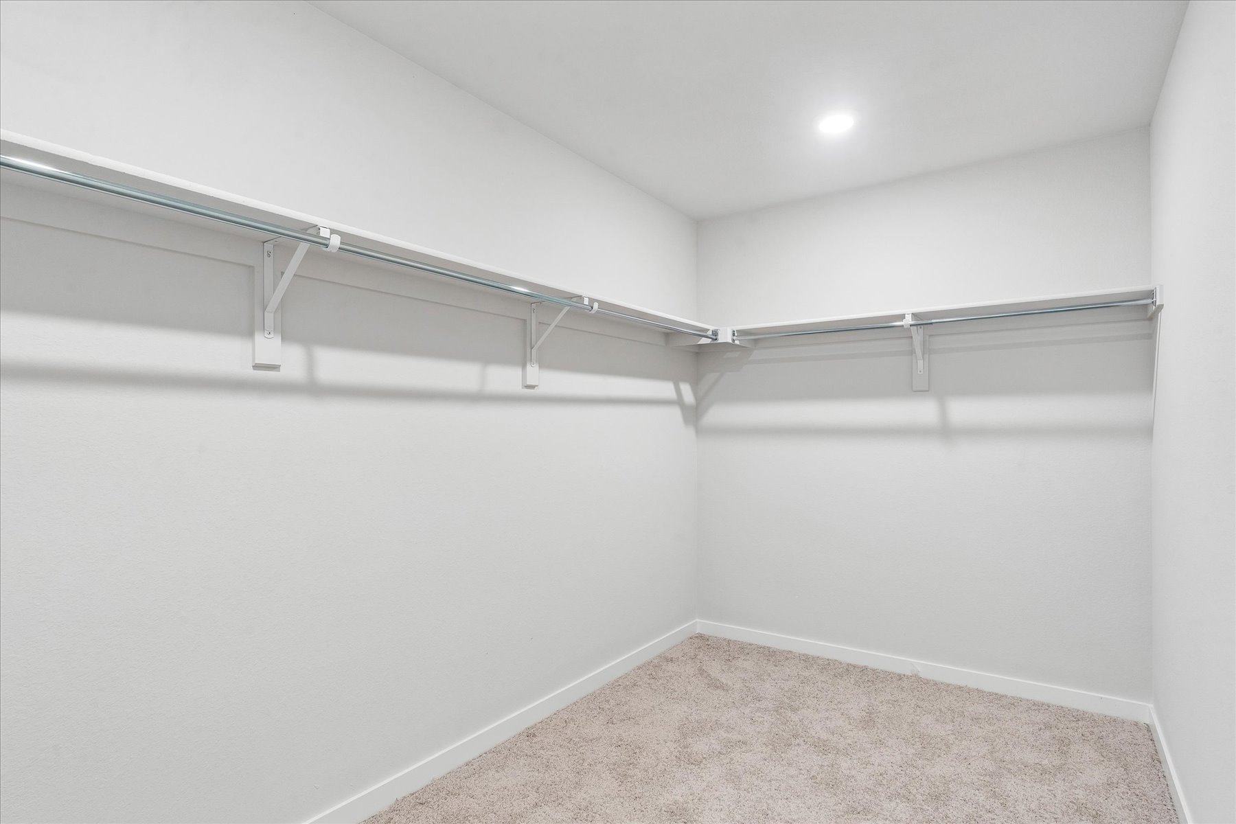 A white room with a metal railing.