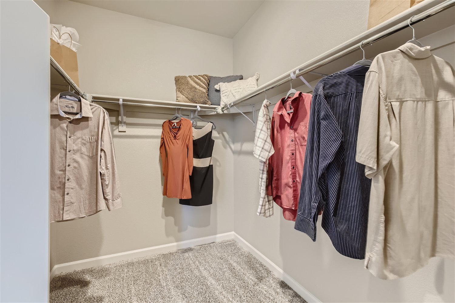 A room with a rack of clothes.