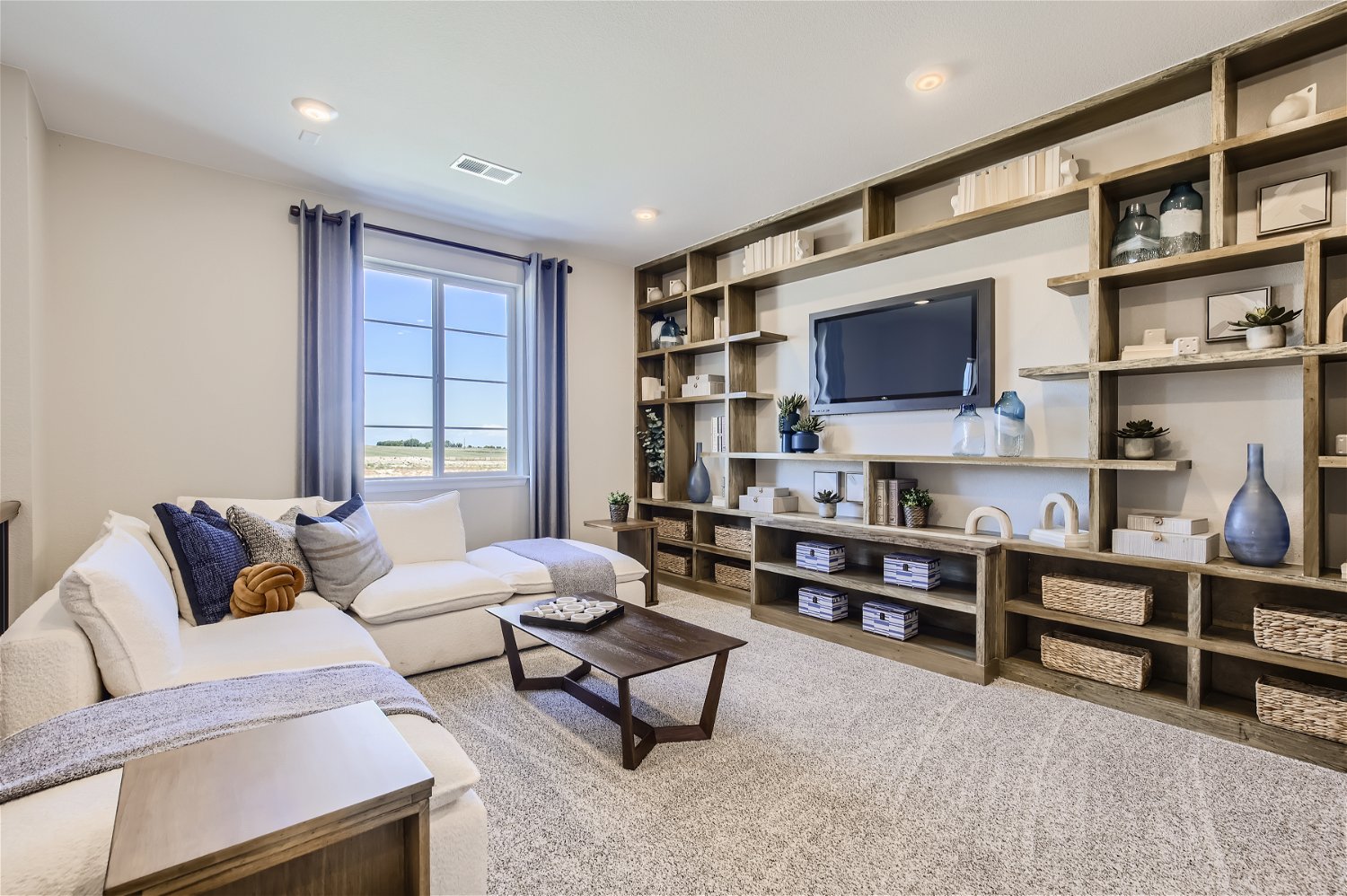 A living room with a tv and couches.