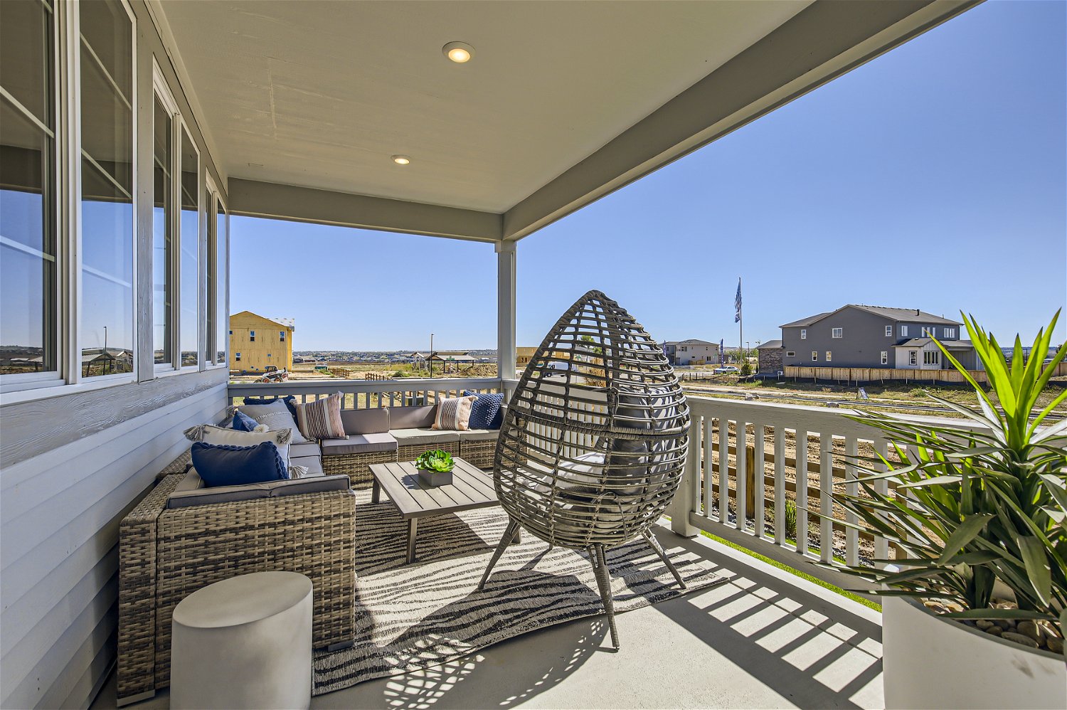 A patio with a chair and a table and chairs on it.