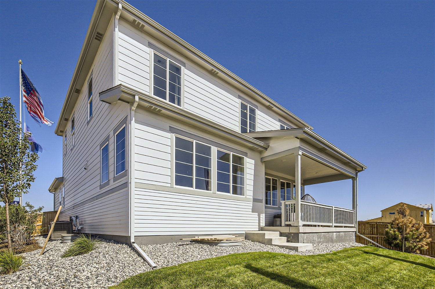 A white house with a flag on the roof.