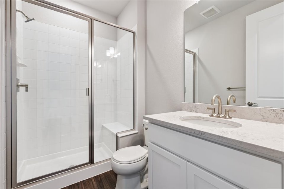 A bathroom with a glass shower.