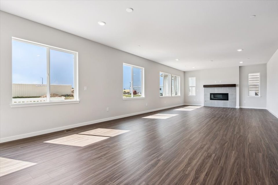 A large empty room with a fireplace.