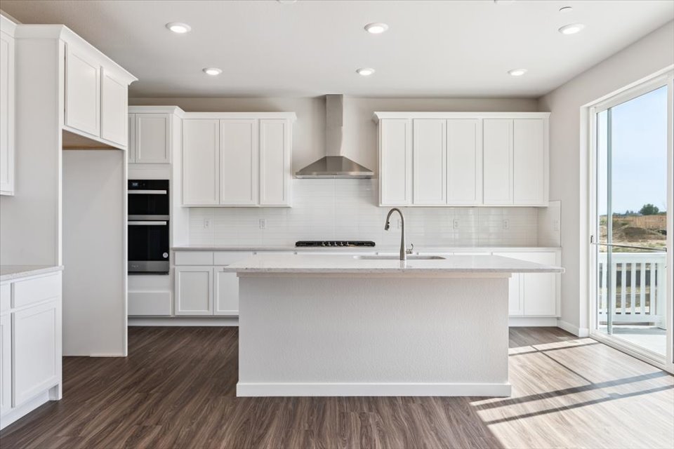 A kitchen with white cabinets.
