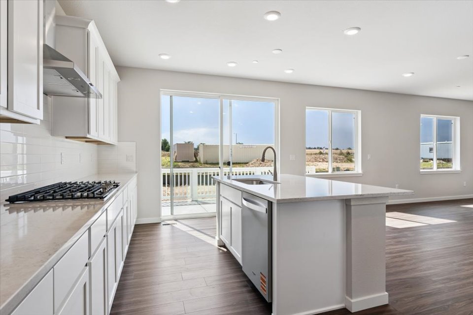A kitchen with white cabinets.