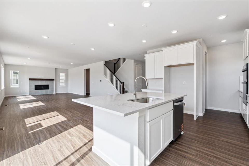 A kitchen with white cabinets.