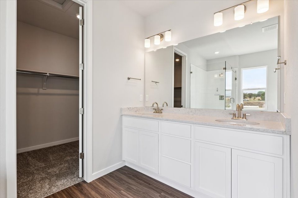 A bathroom with white cabinets.