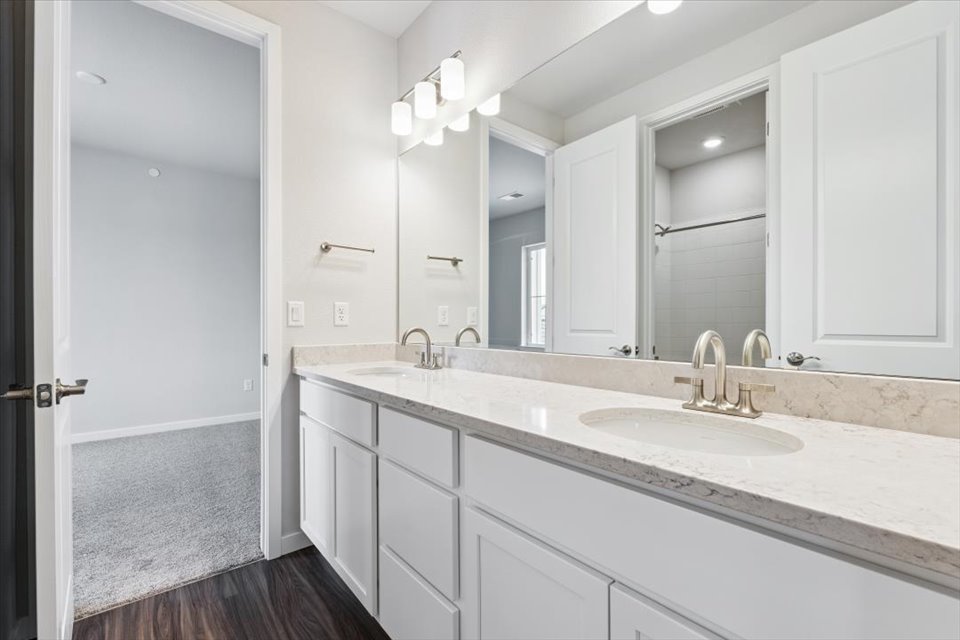 A bathroom with a large mirror.