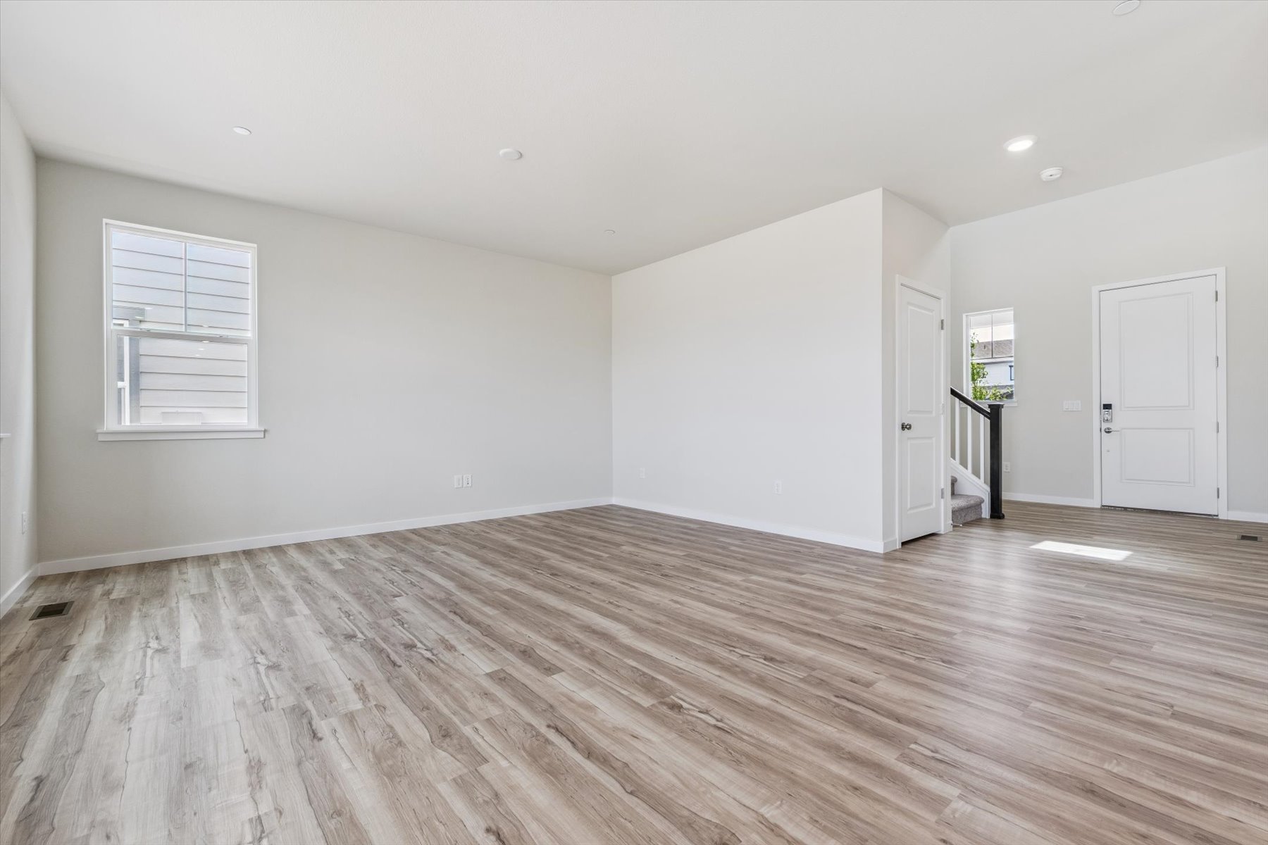 A room with a wood floor and white doors.