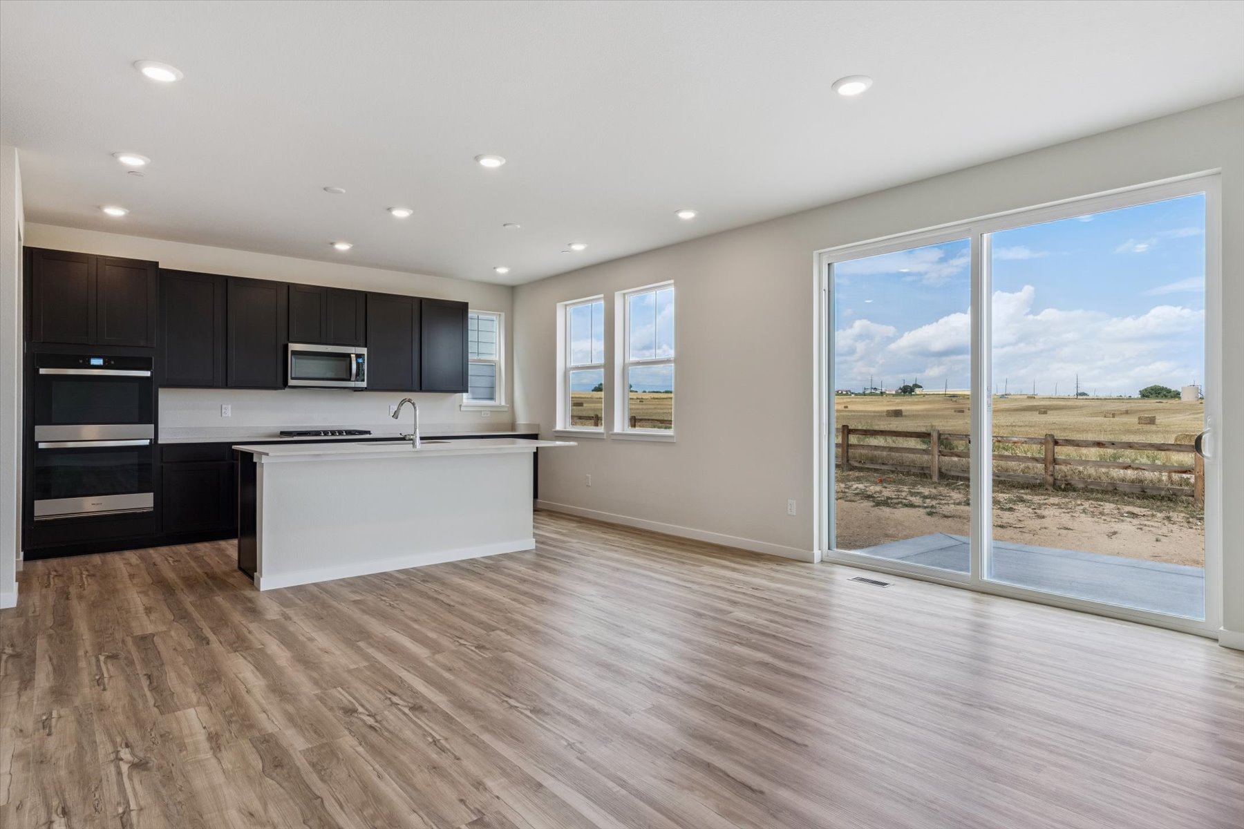 A kitchen with a large window.