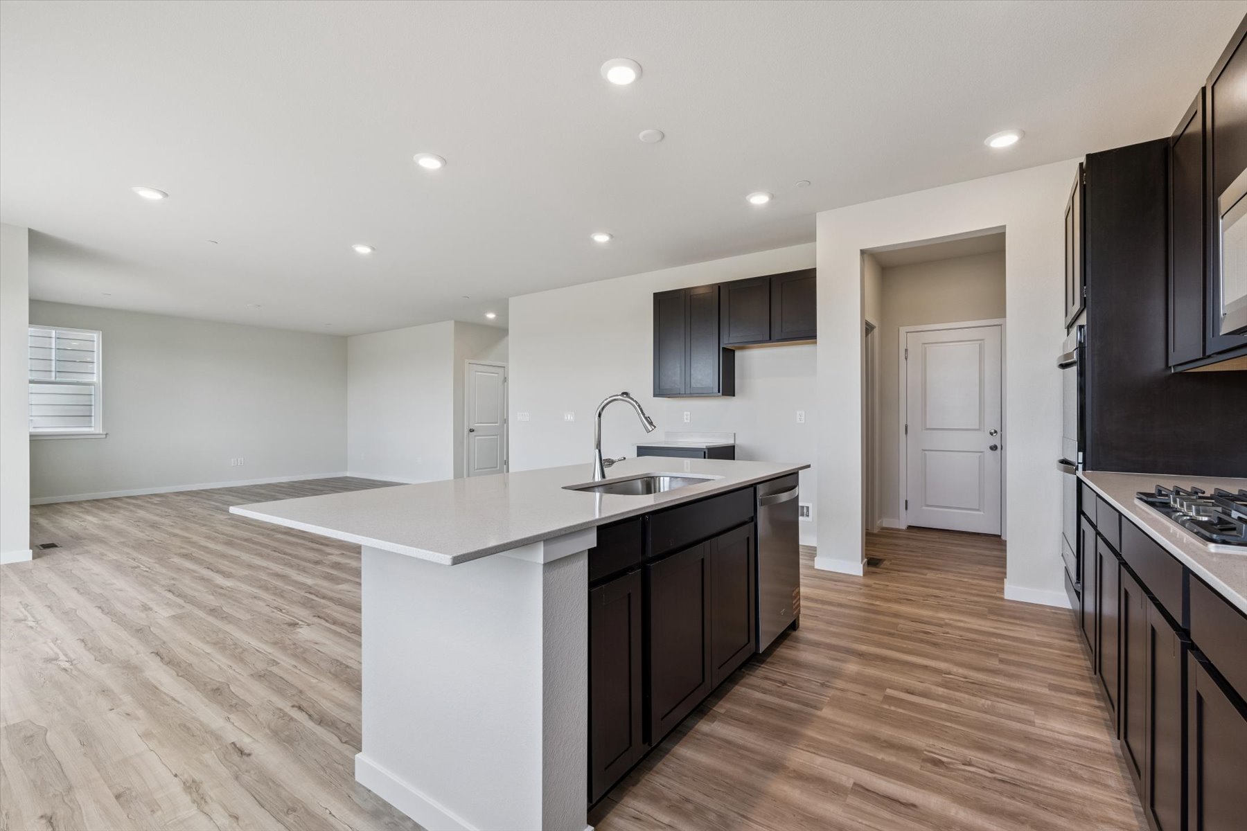 A kitchen with black cabinets.