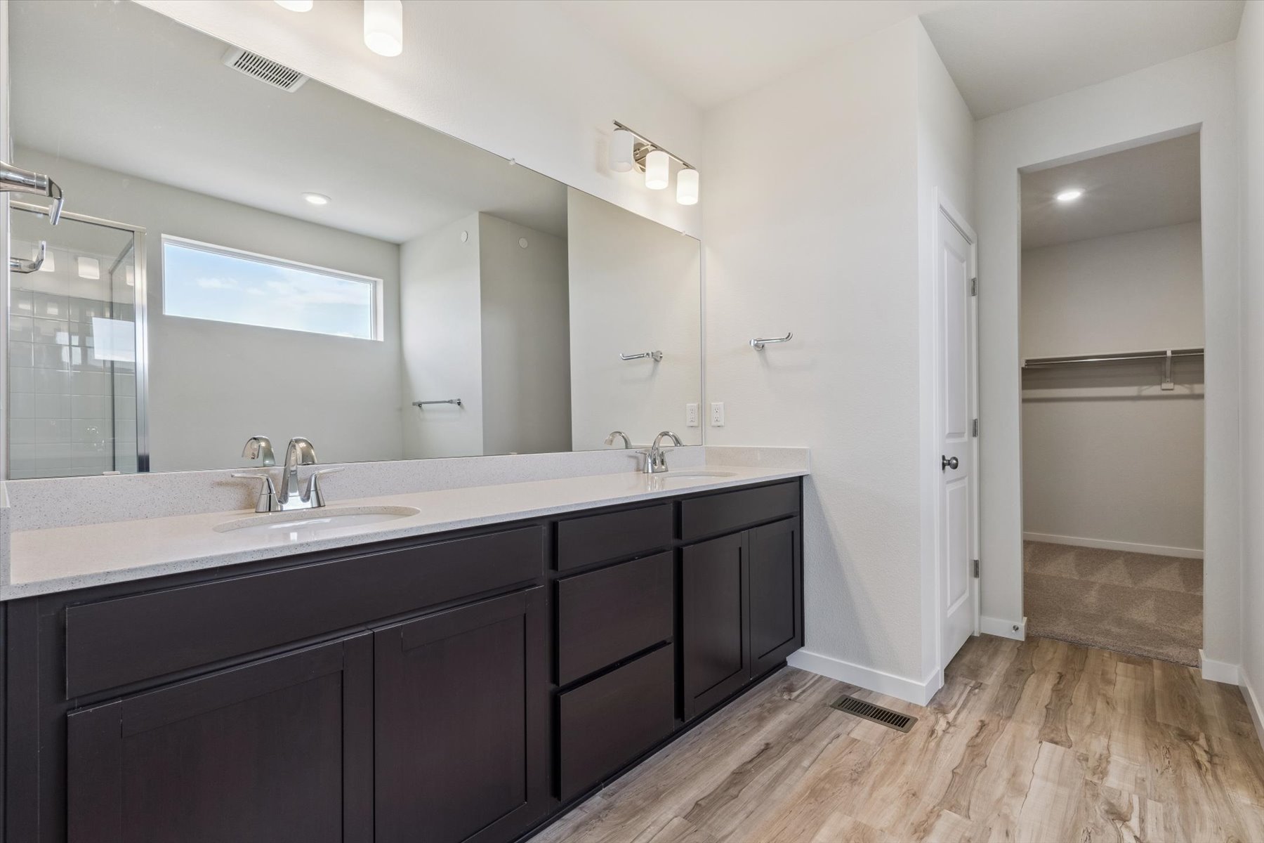 A bathroom with a large mirror.