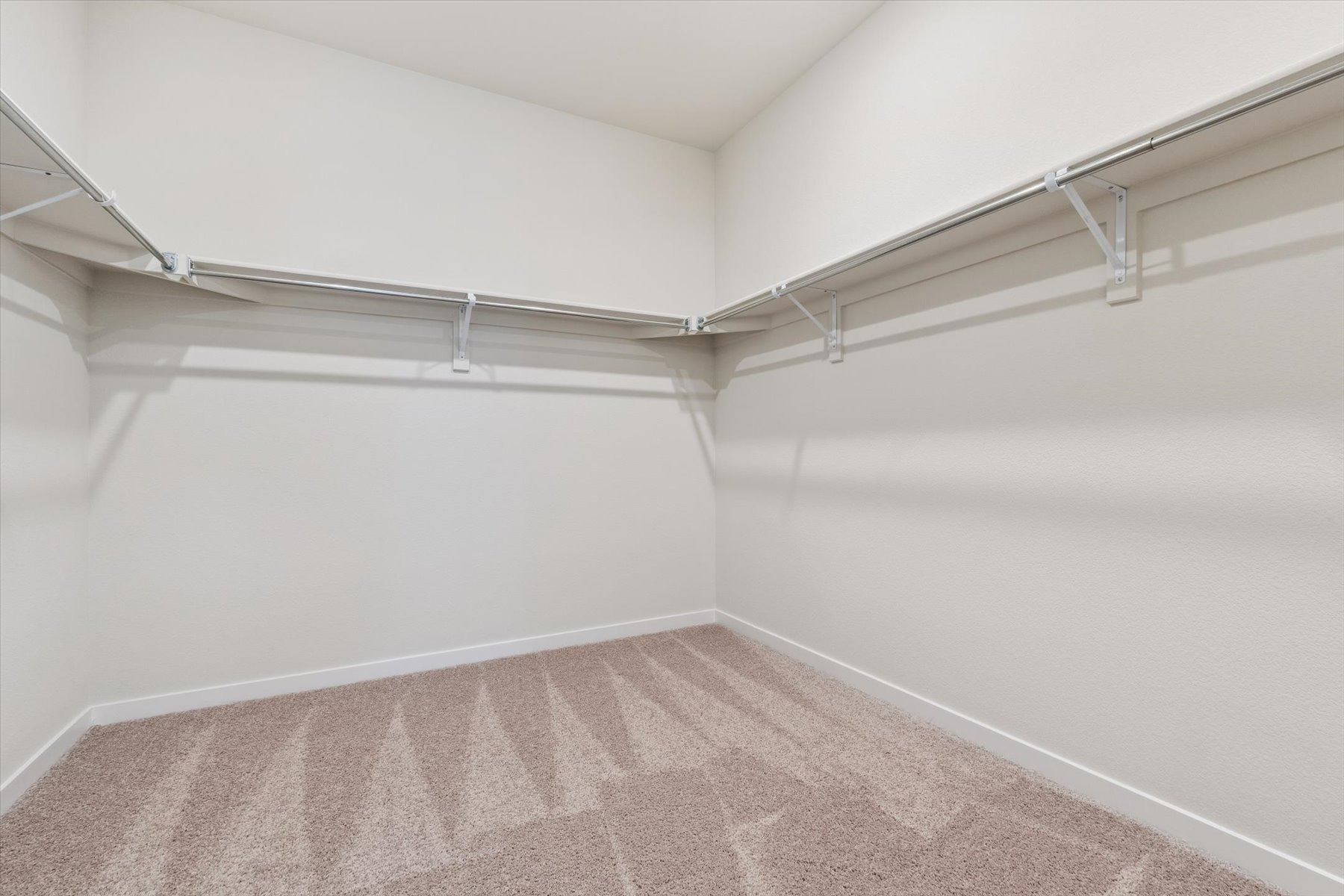 A white room with a carpet.