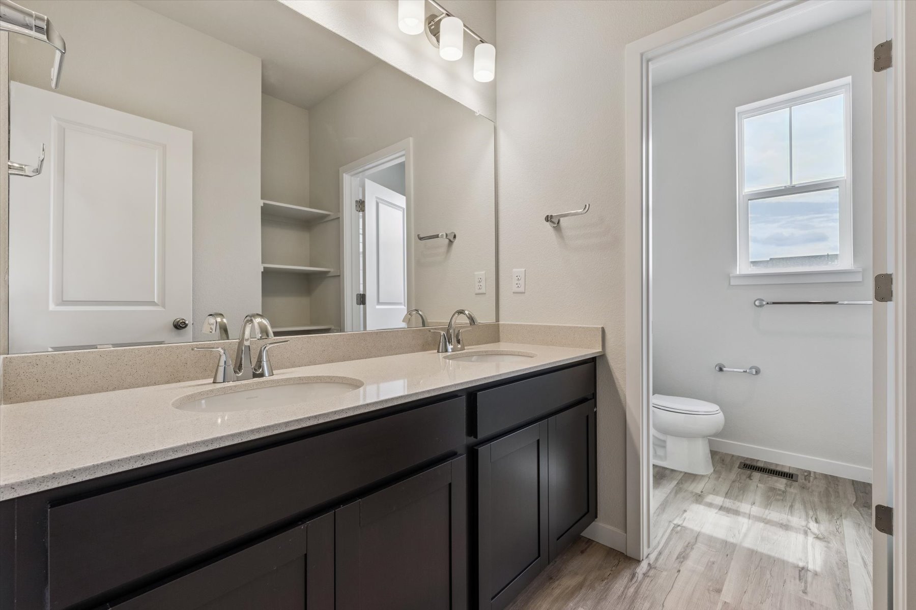 A bathroom with a large mirror.