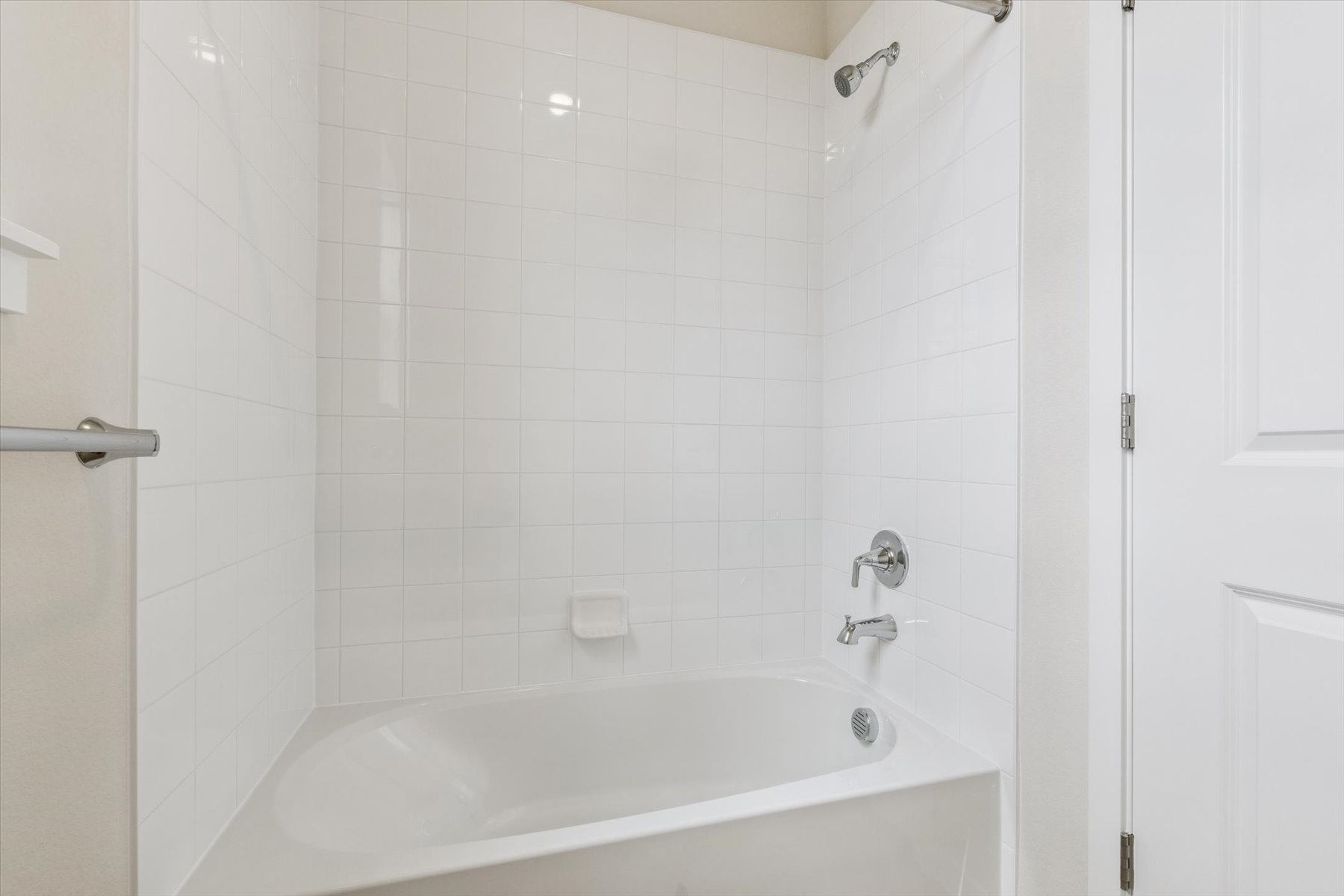 A bathtub in a bathroom.