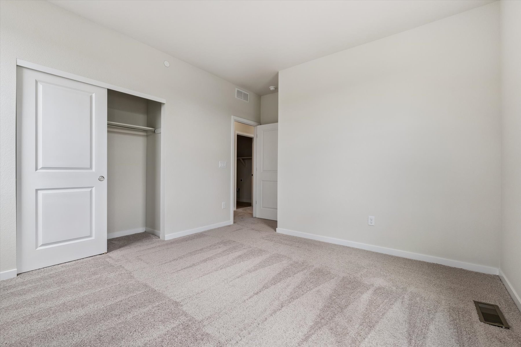 A hallway with white doors.