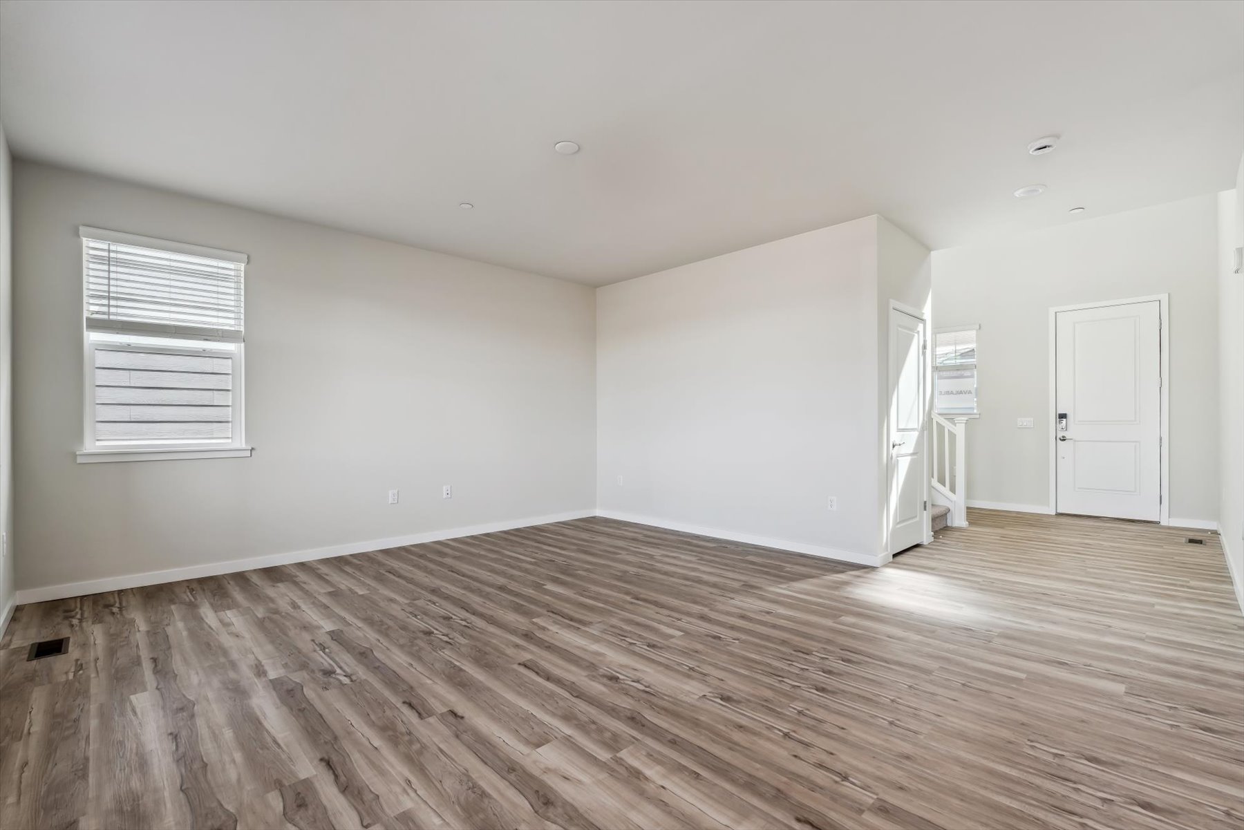A room with a wood floor and white walls.