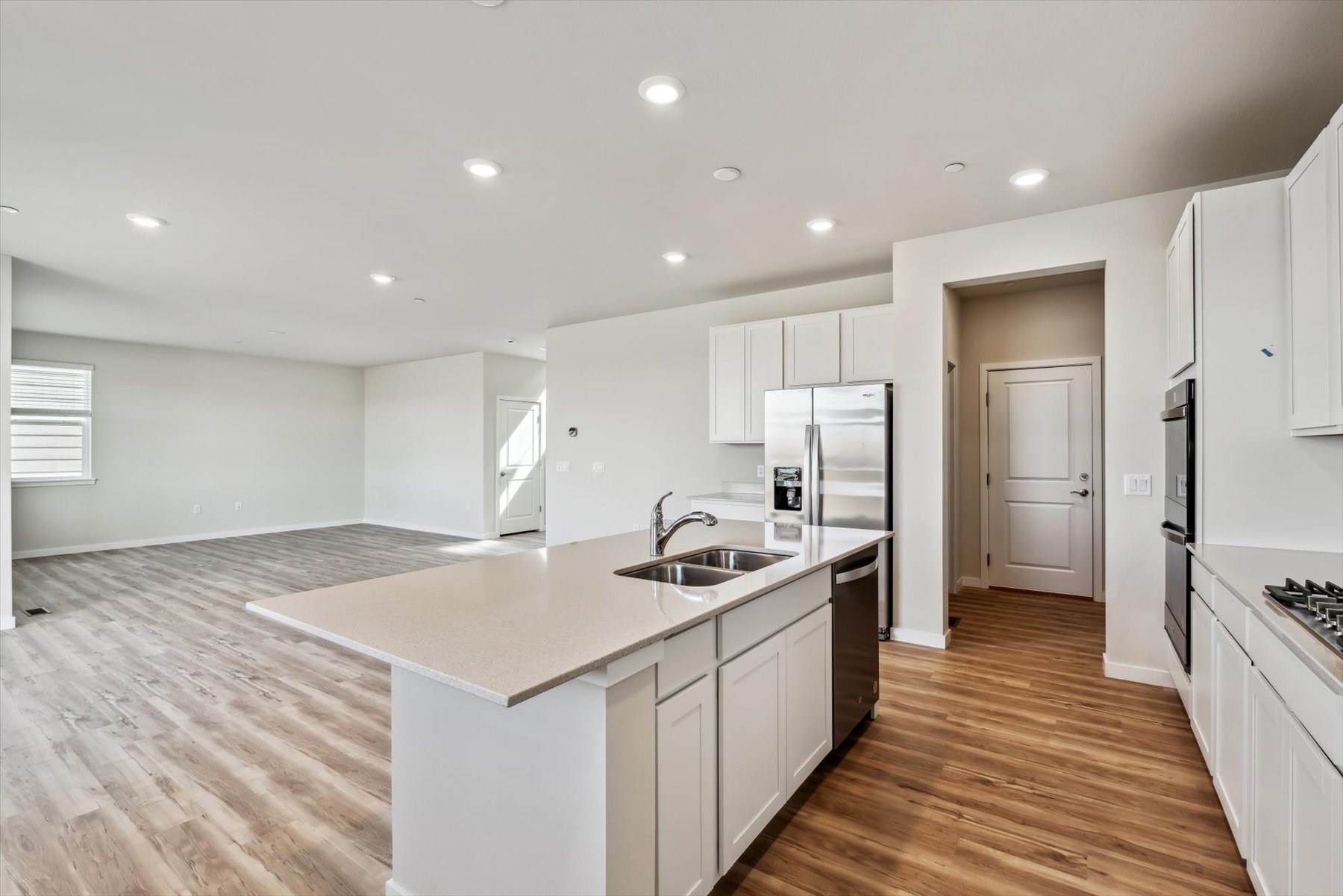 A kitchen with white cabinets.