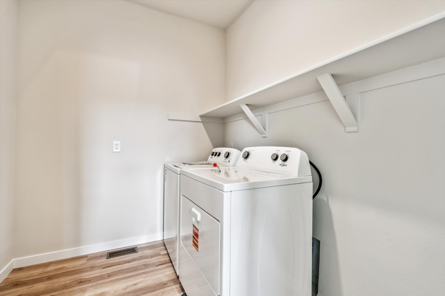 A white kitchen with a white stove.