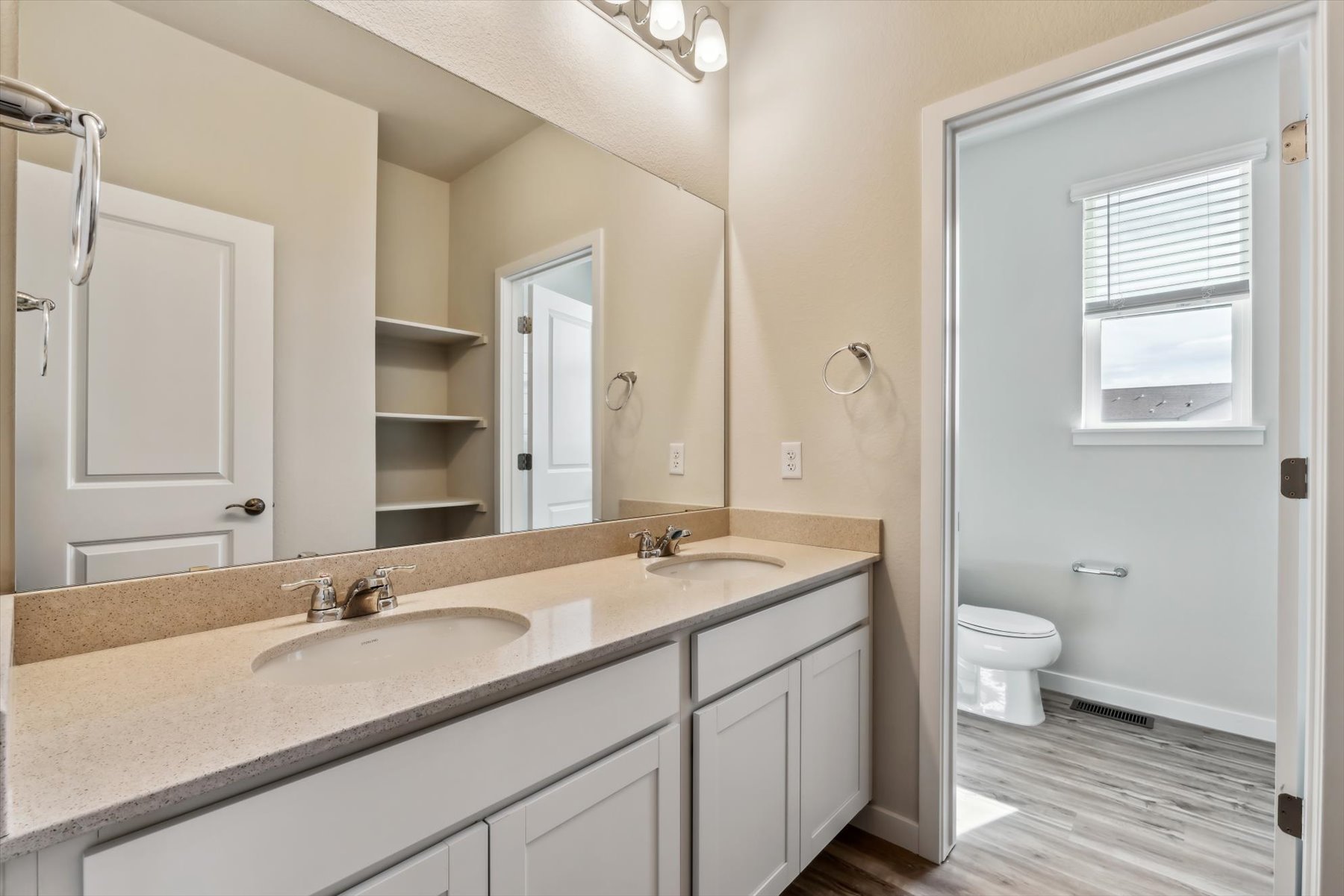 A bathroom with a large mirror.