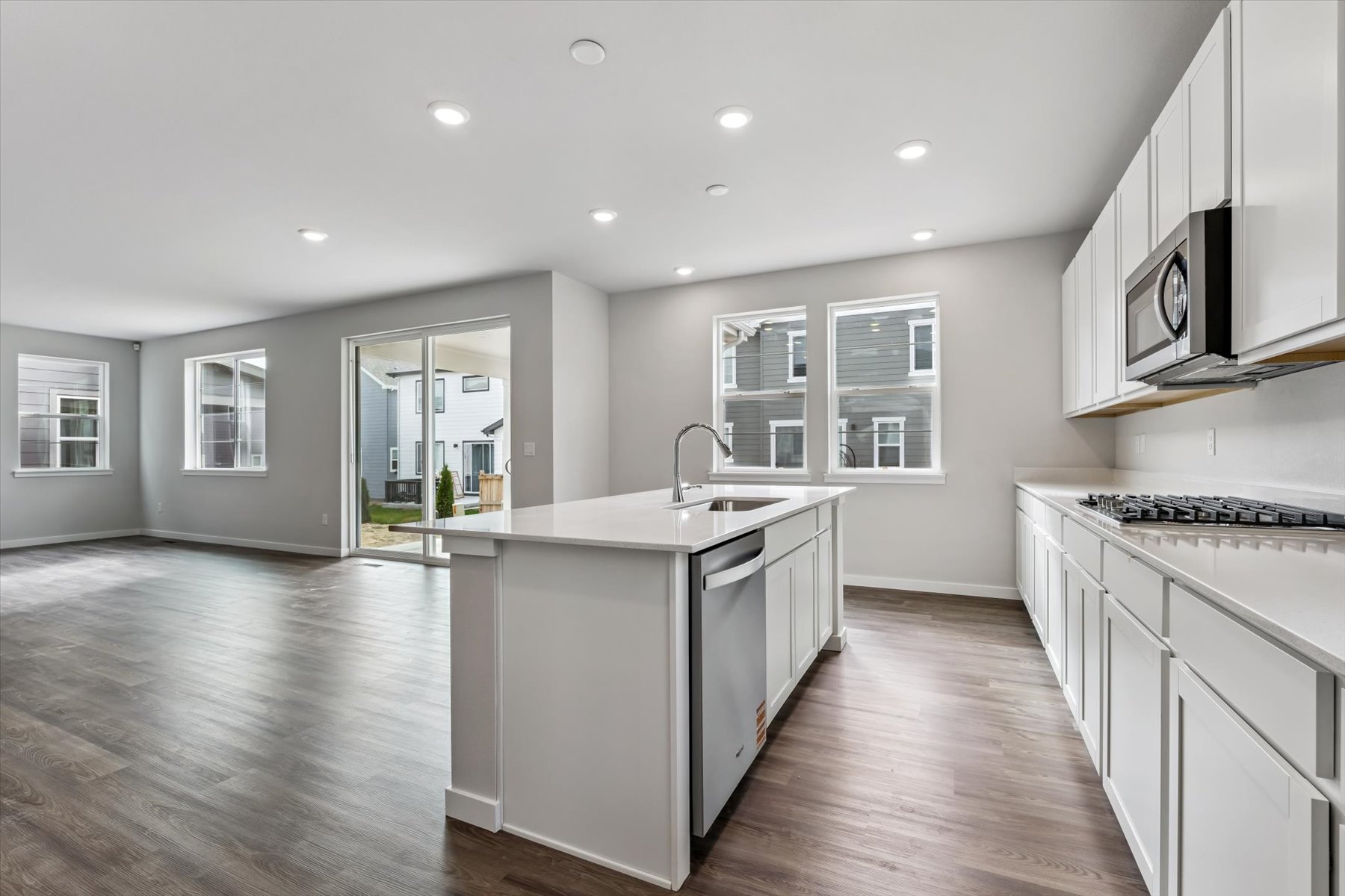 A kitchen with white cabinets.