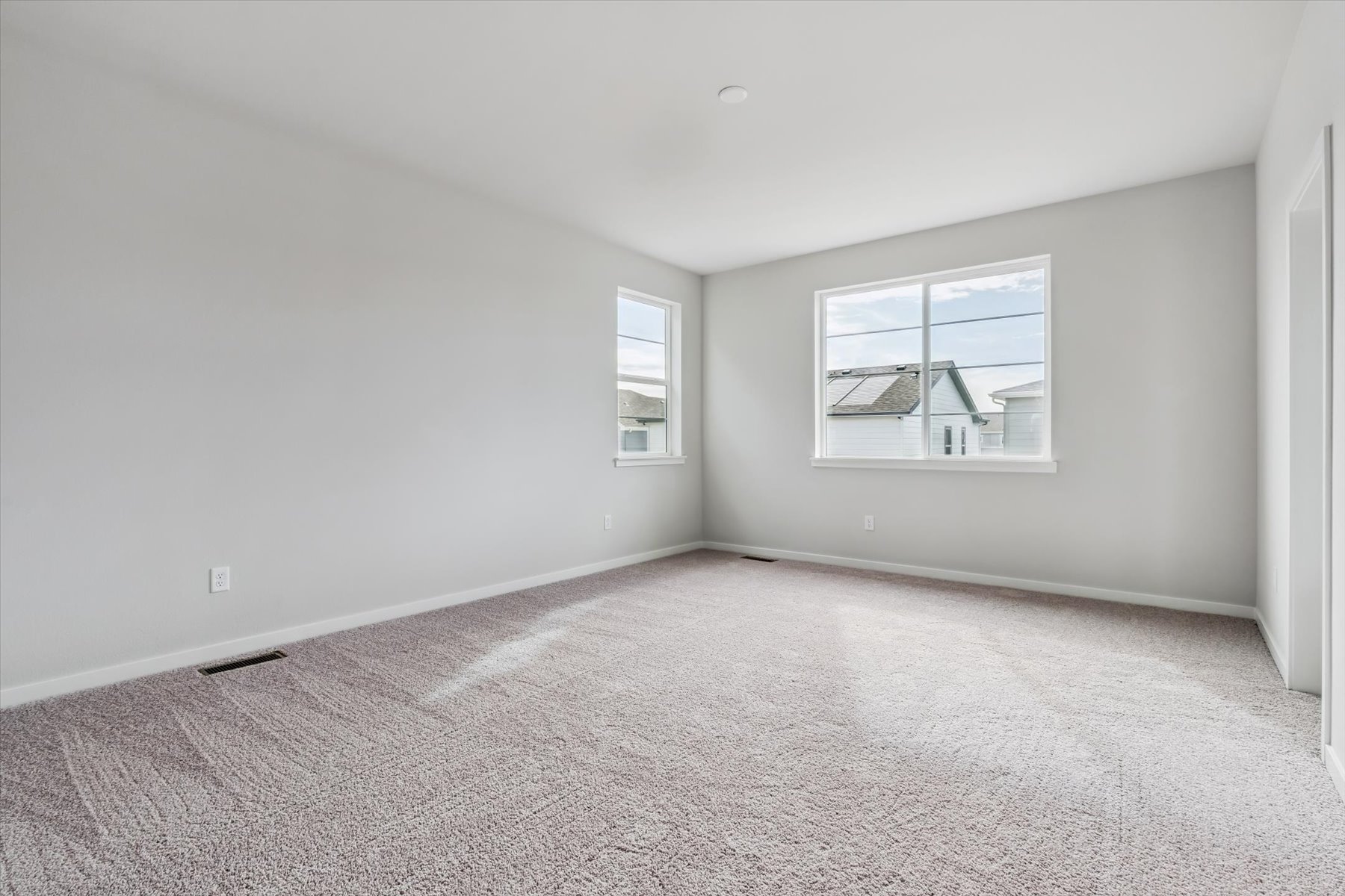 A room with a window and a carpet.