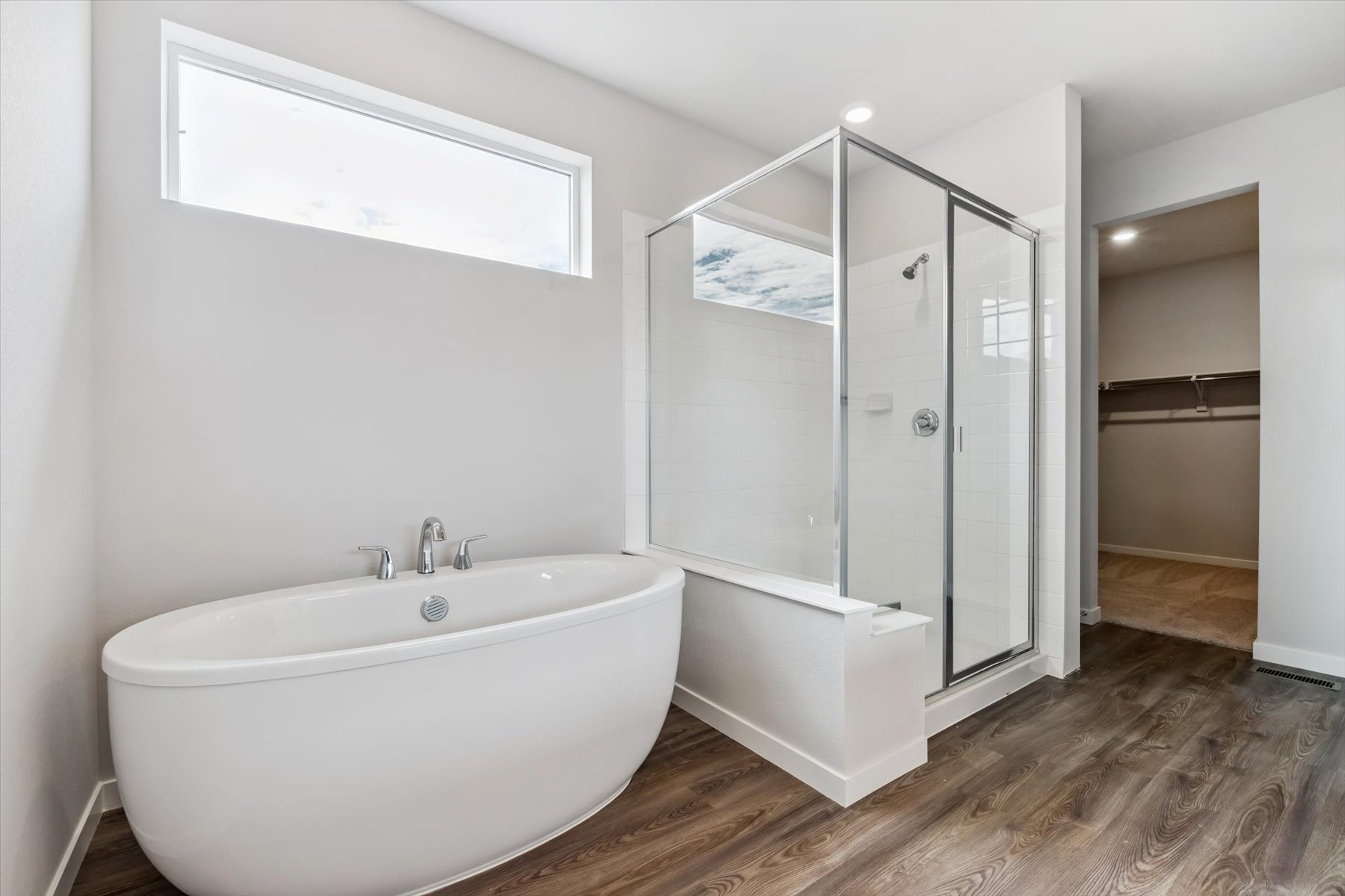 A bathroom with a tub and shower.