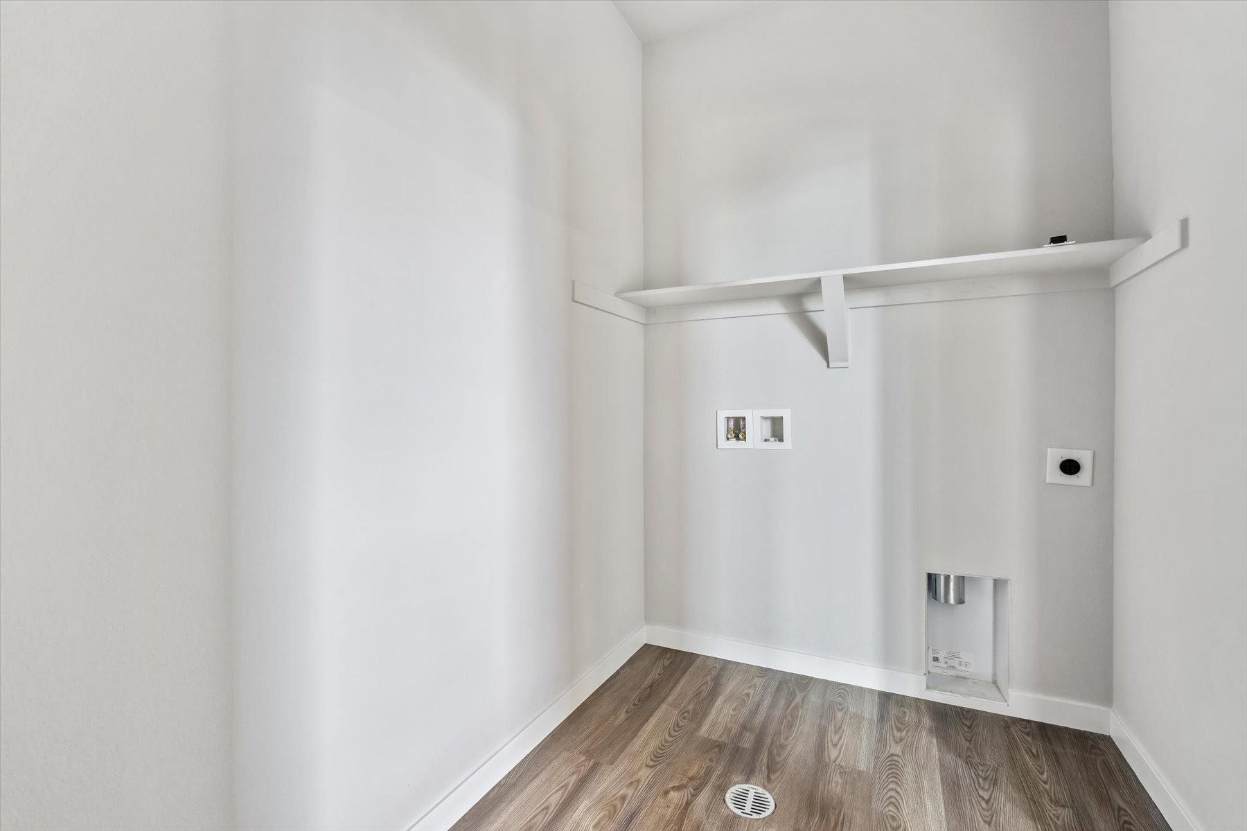 A white room with a wood floor.