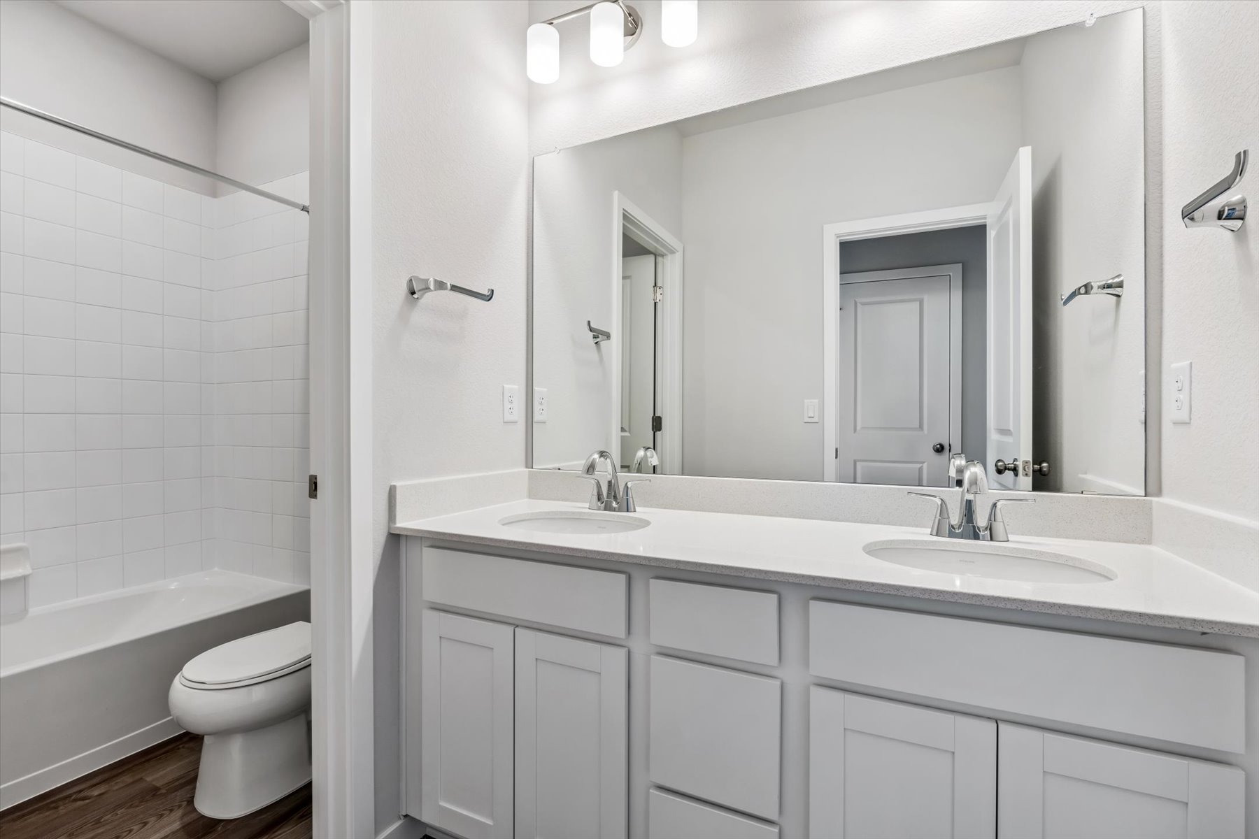 A bathroom with a tub sink and toilet.
