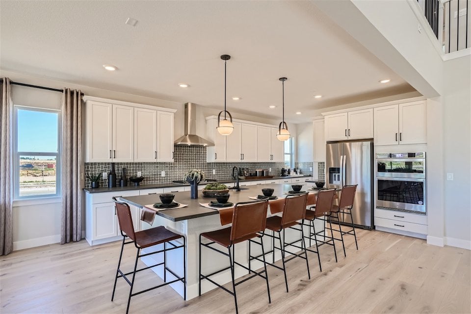 A kitchen with a bar and island.
