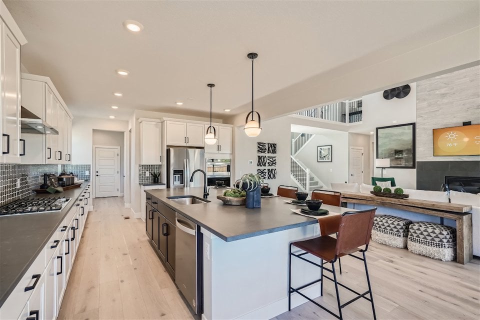 A kitchen with a bar and island.