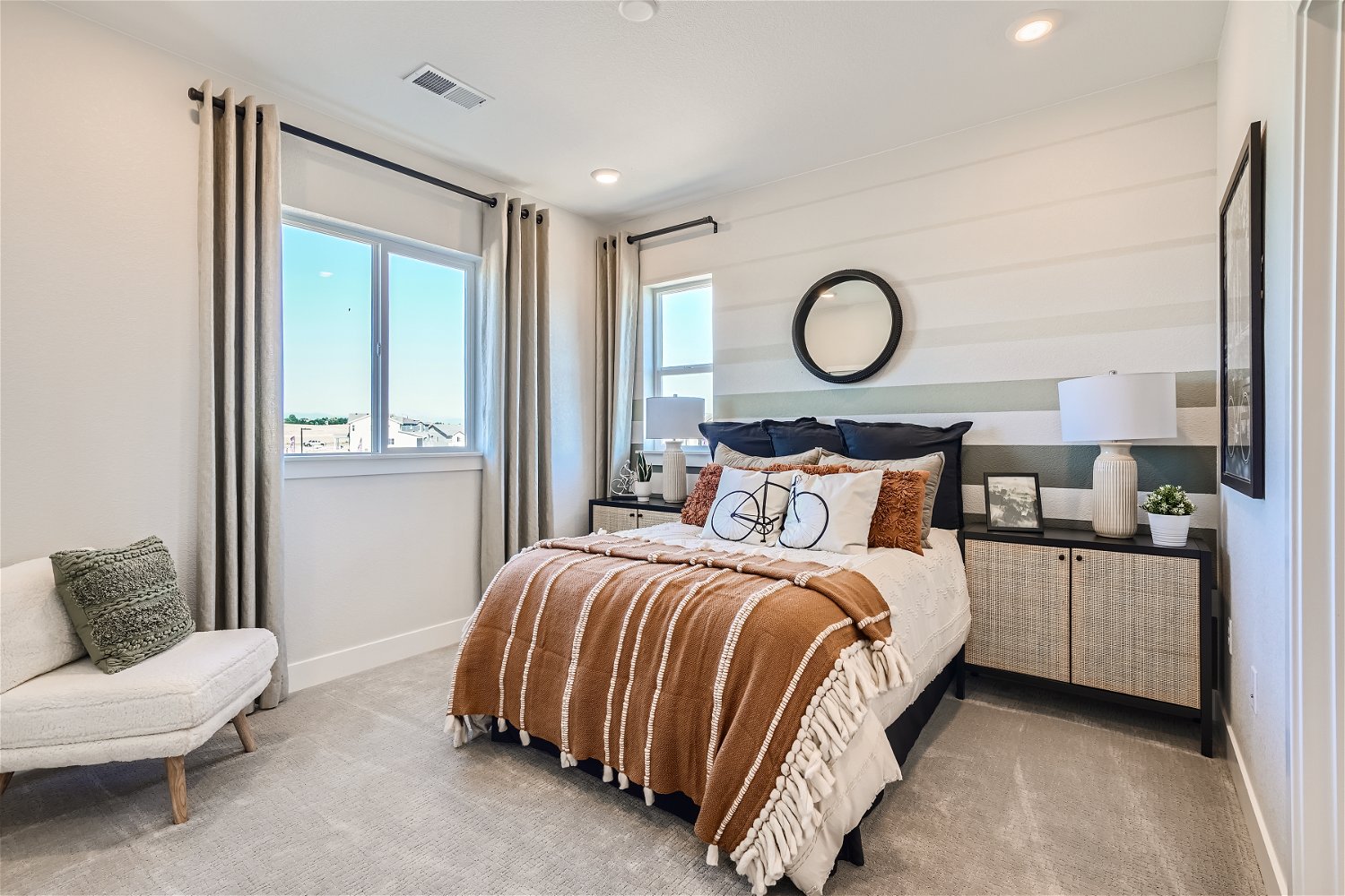 A bedroom with a bed and a chair.