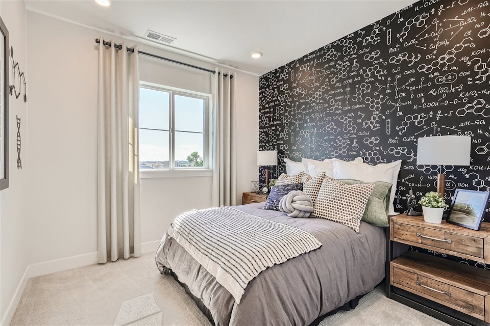 A bedroom with a bed and a window.