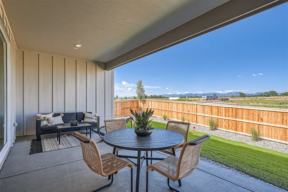 A patio with a table and chairs.