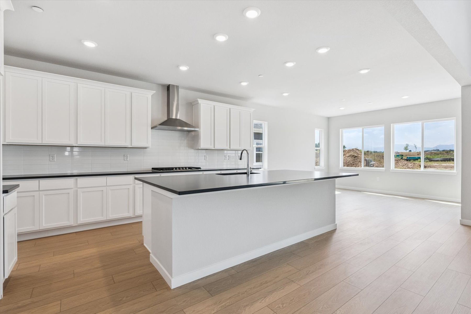 A kitchen with white cabinets.