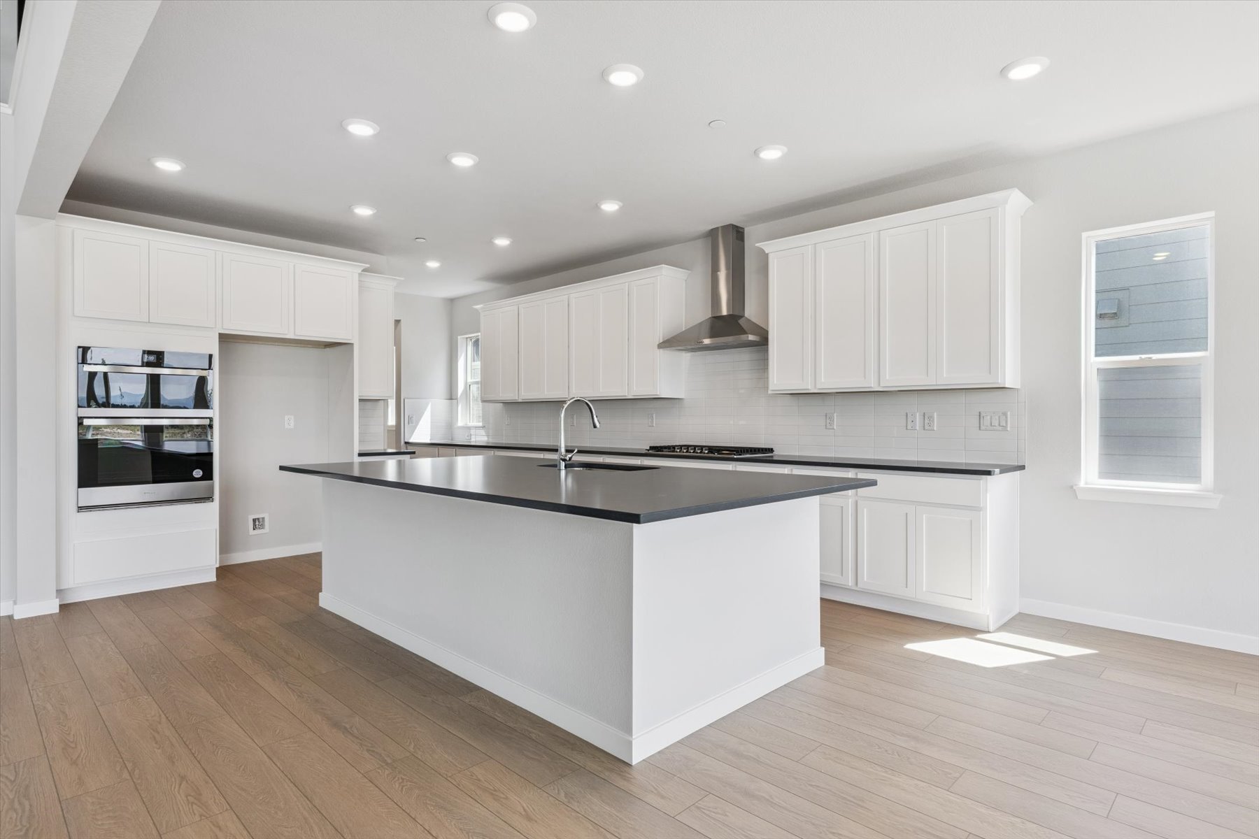 A kitchen with white cabinets.