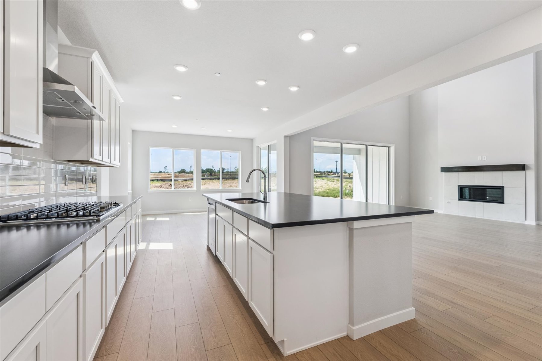 A kitchen with white cabinets.