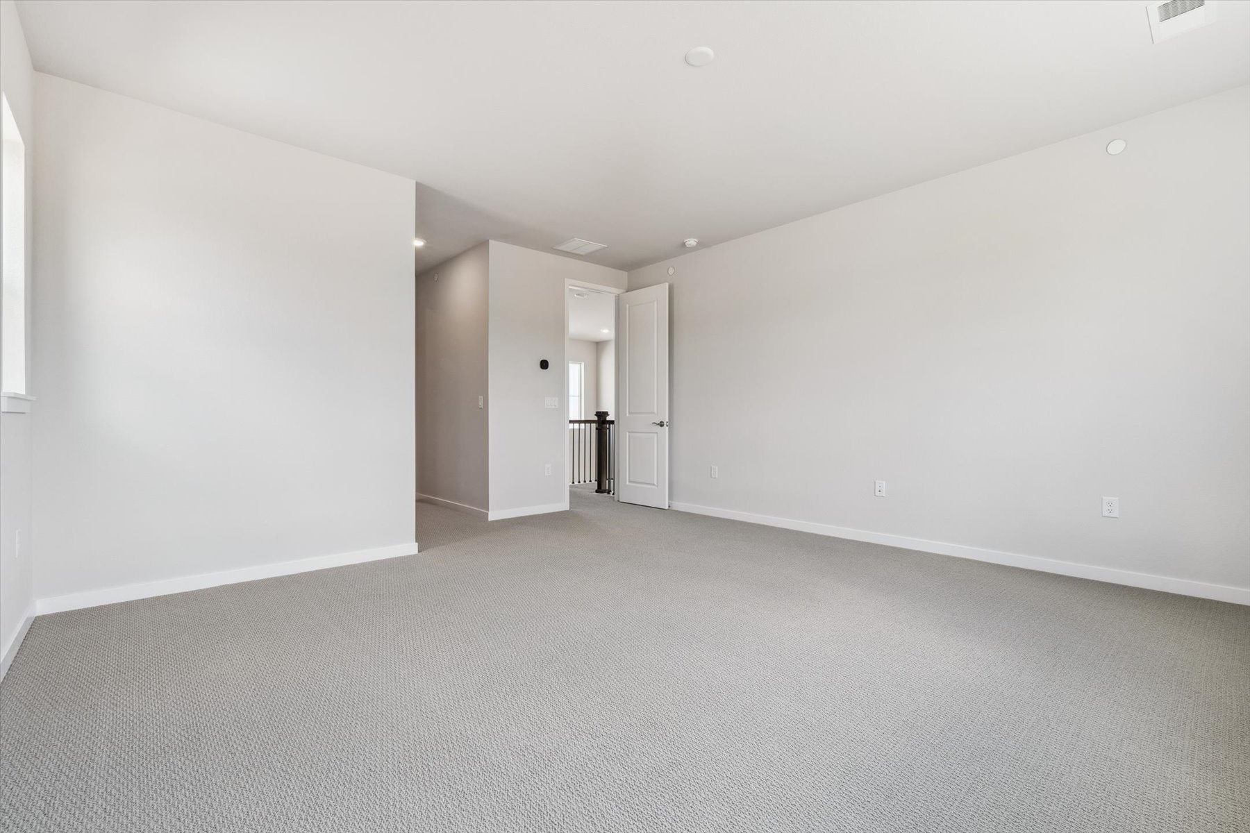 A long hallway with white walls.