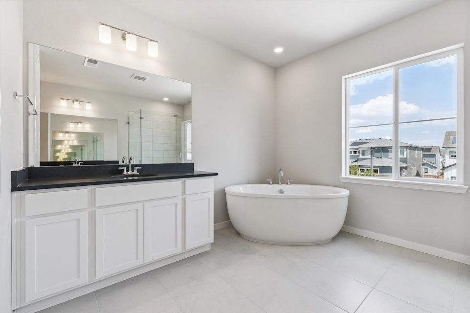 A bathroom with a tub and sink.