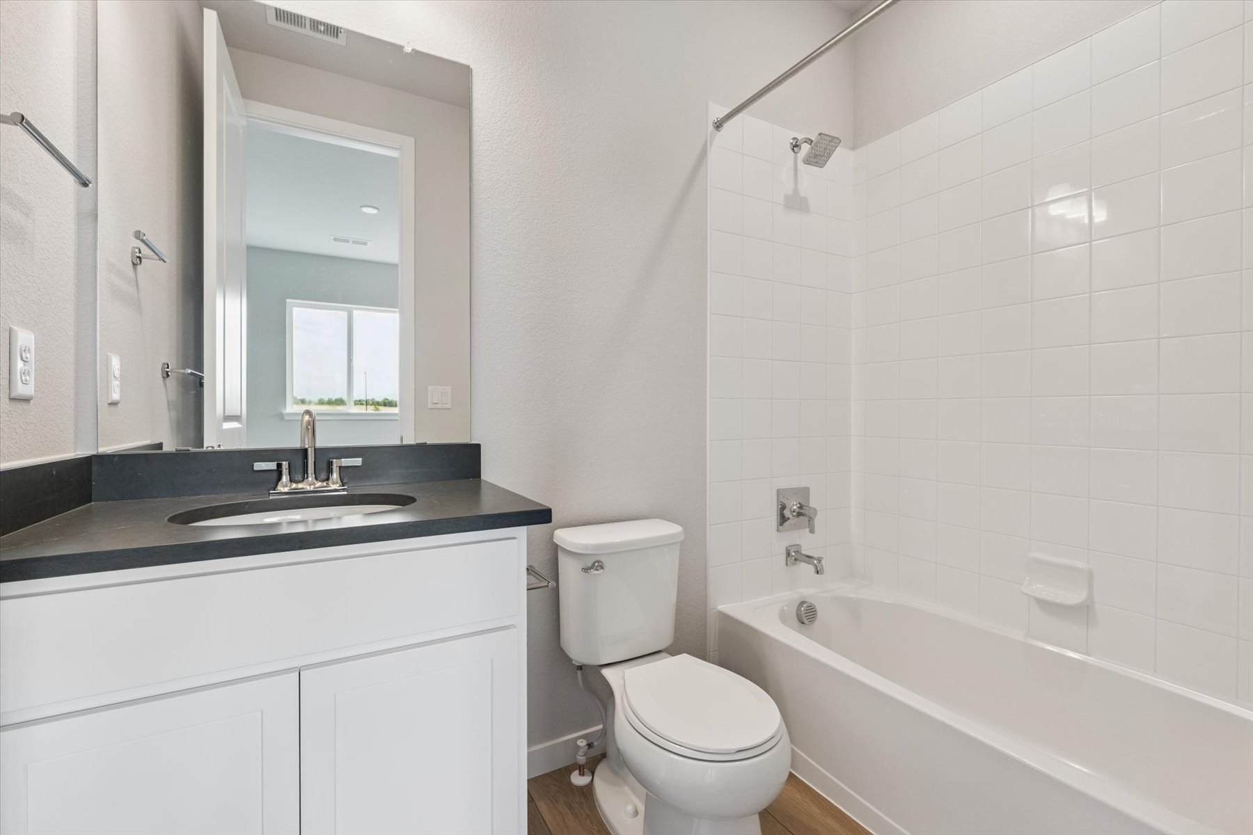A bathroom with a tub sink and toilet.