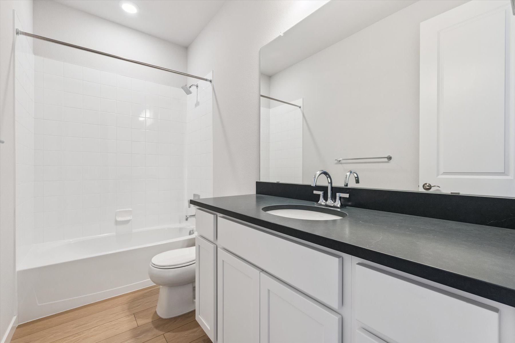 A bathroom with a black countertop.