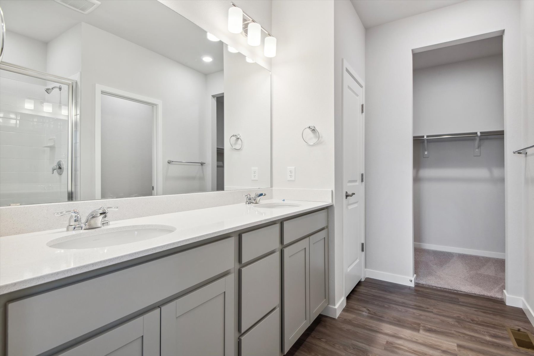A bathroom with a large mirror.