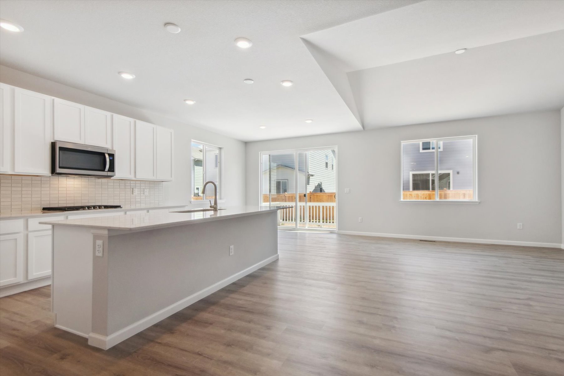 A kitchen with white cabinets.