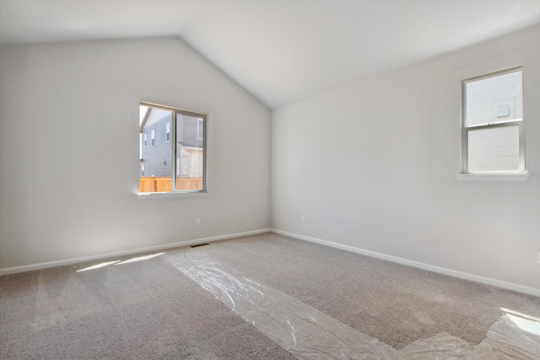 A room with a window and a carpet.