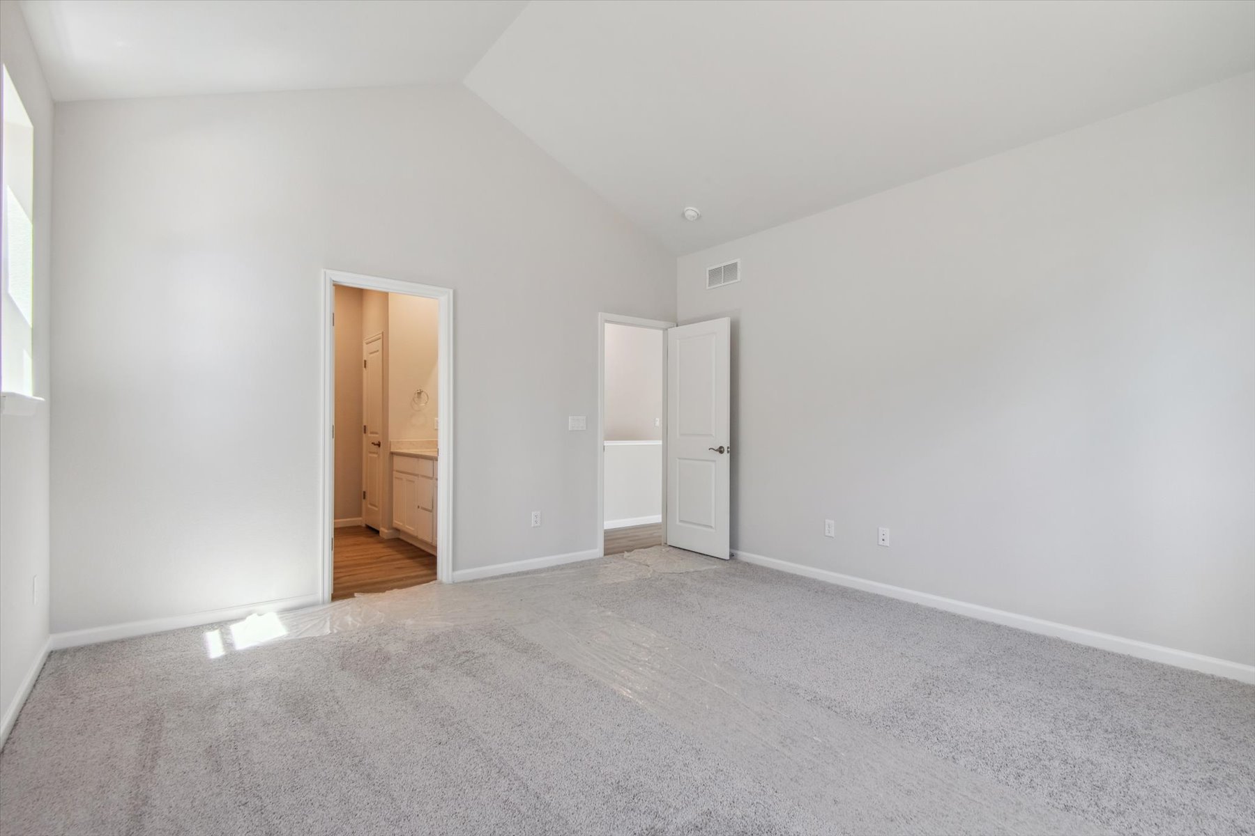 A hallway with white walls.